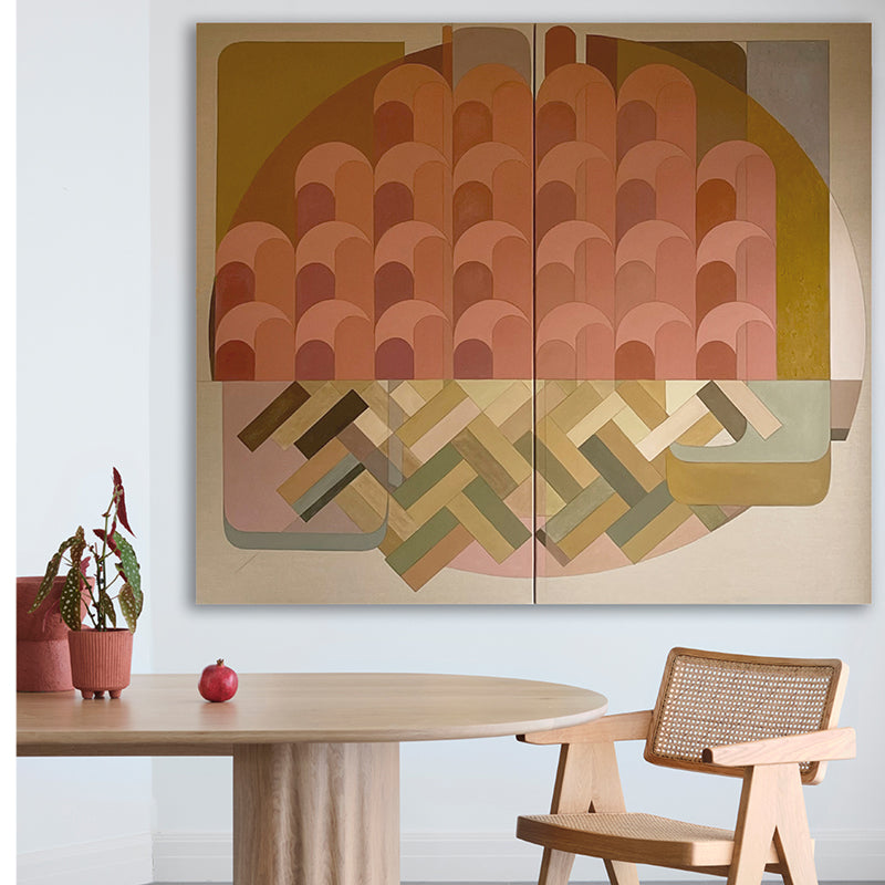 Abstract geometric wall art in a room with a table and chair.