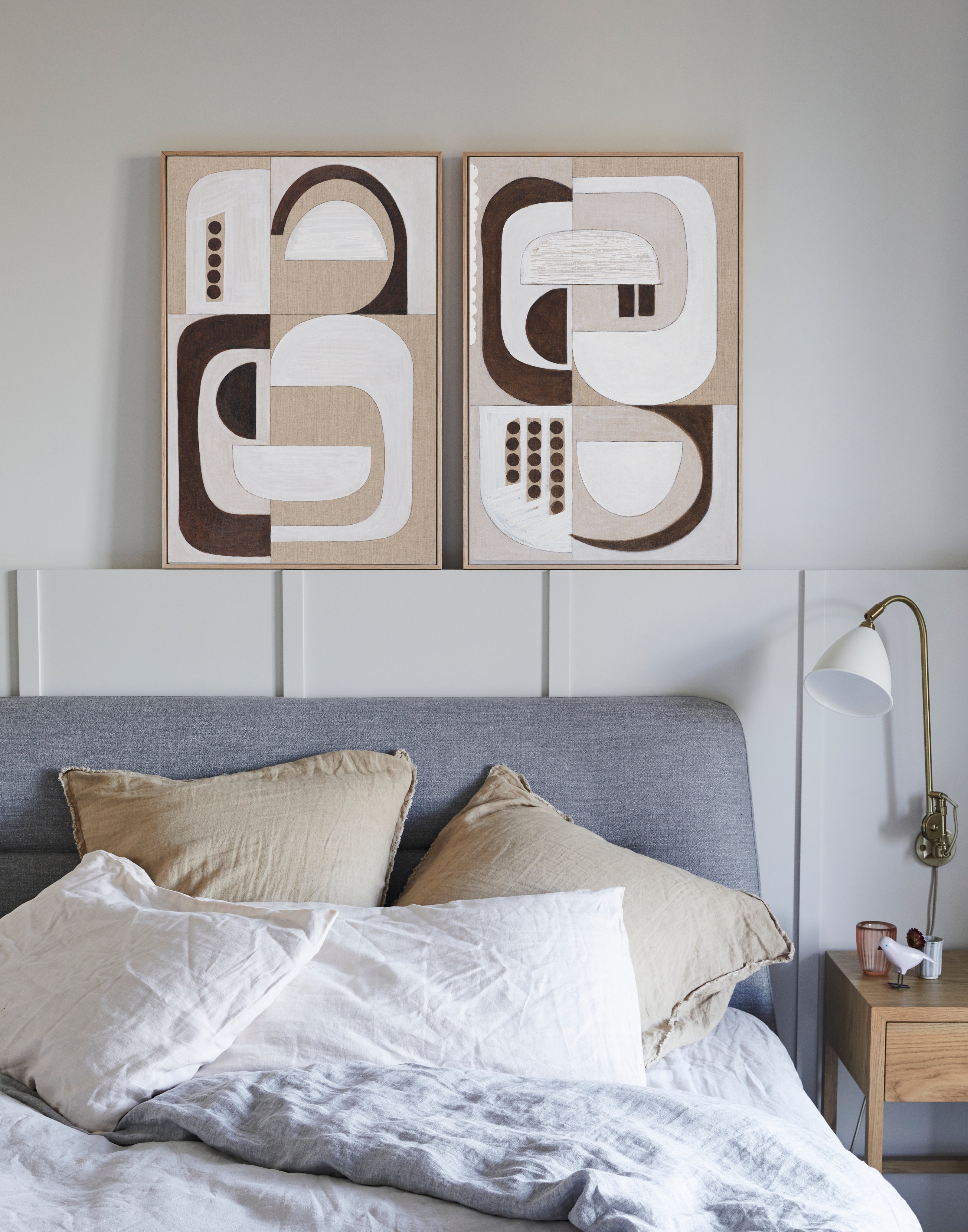 Bedroom with abstract wall art above a bed